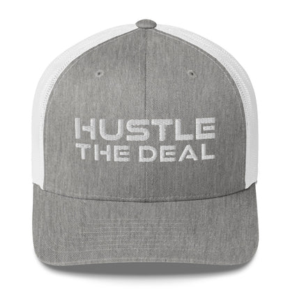White and heather grey trucker hat with embroidered Hustle The Deal logo